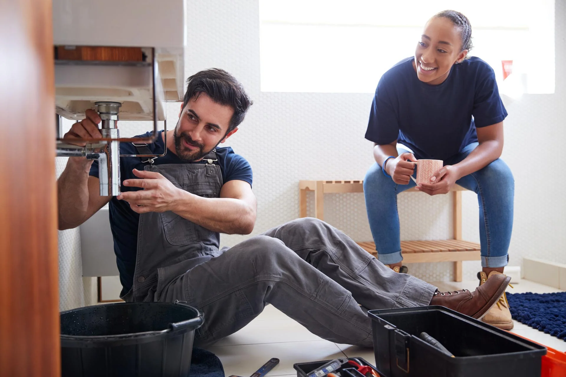 Plumbing Services | Drainage & Plumbing Ltd 2 Plumbing engineer and apprentice repairing a sink