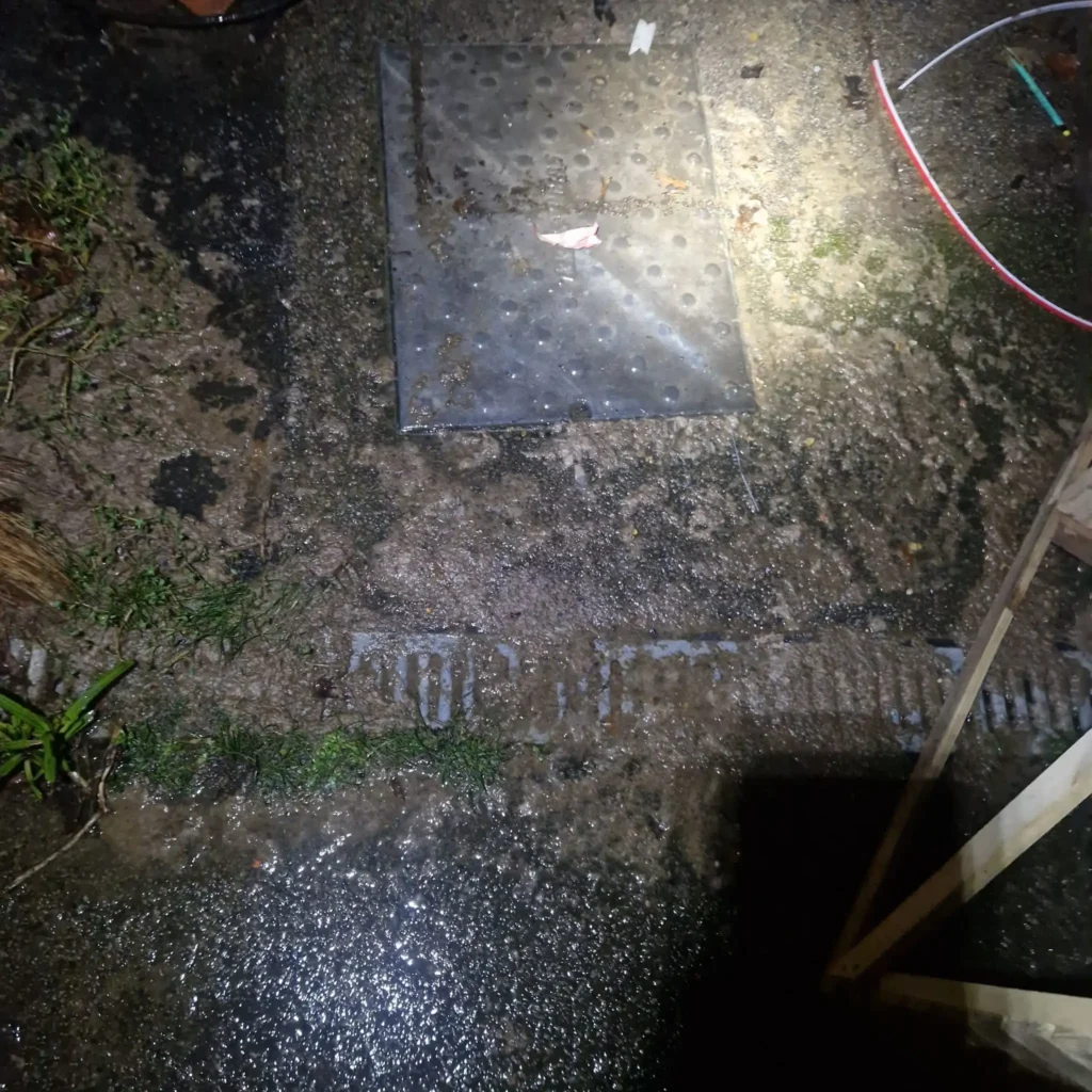 Blocked drain in Bromley with overflowing outside manhole