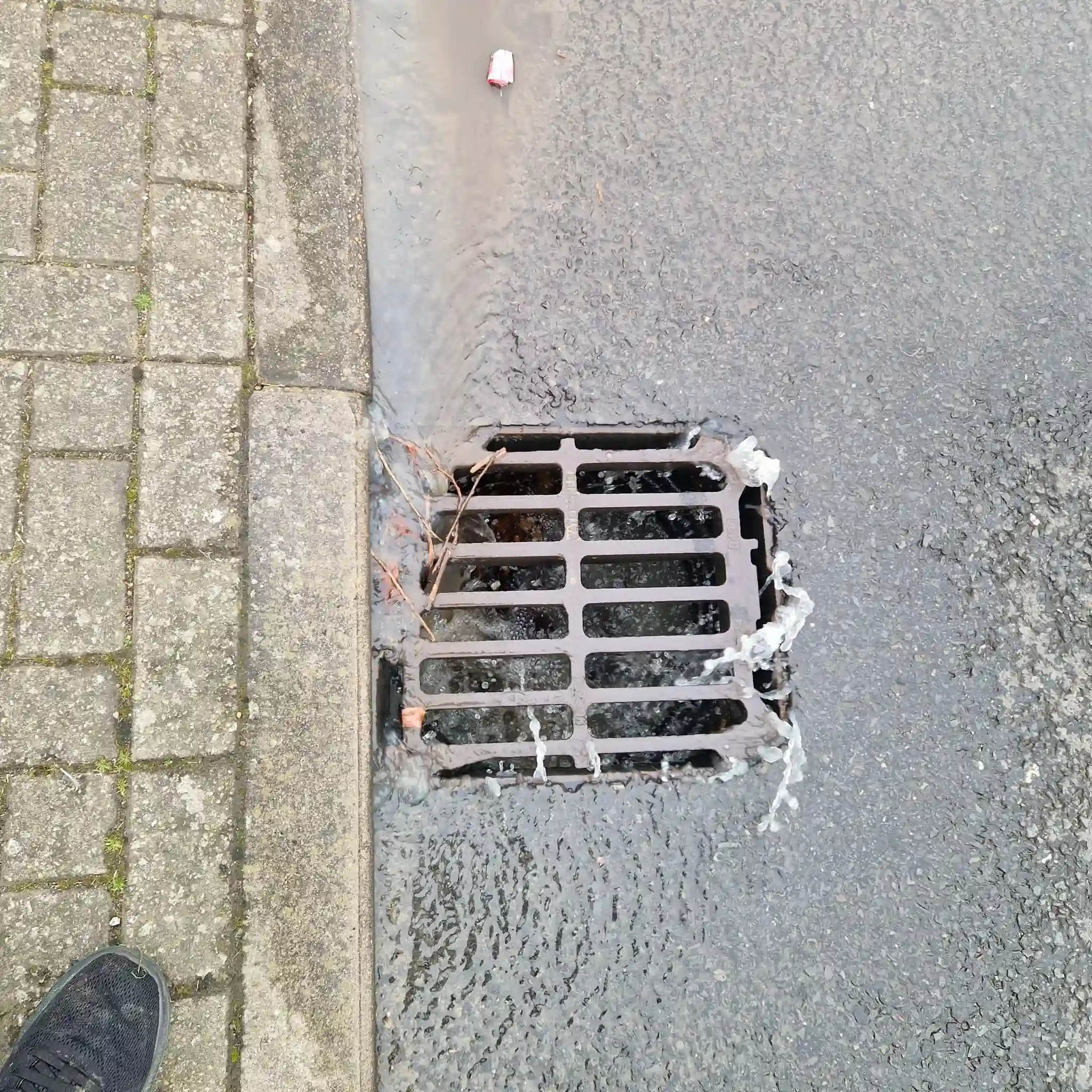 High-pressure water jetting cleaning a drain back to its full bore in South East England