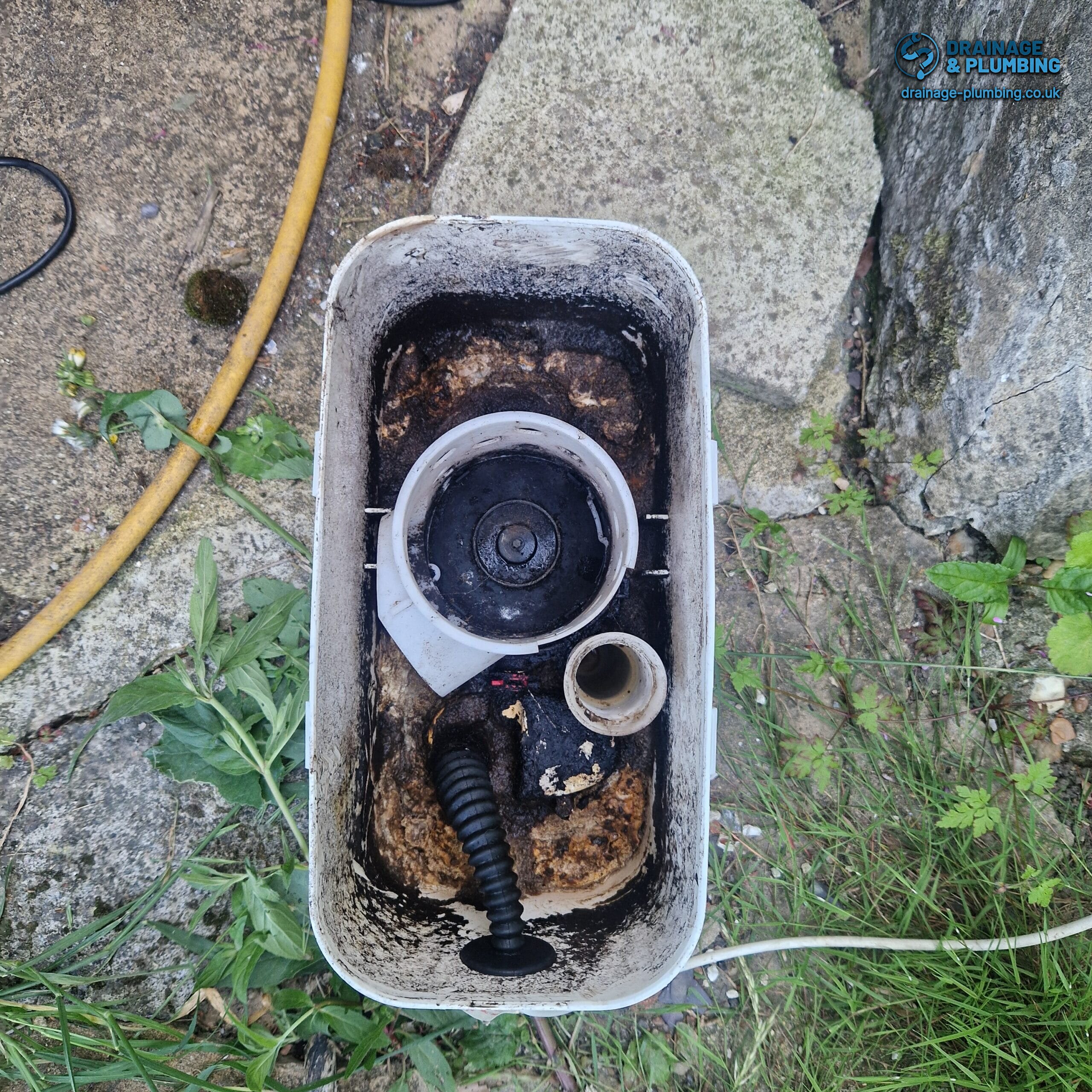 engineer working at a residential drain, tracing the cause of a blockage before jetting