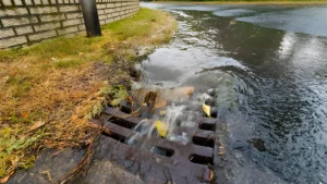 Overflowing drain pipes flooding outdoor area fixed by Drainage & Plumbing LTD