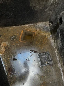 Overflowing outside drain requiring professional drain unblocking in Surrey.