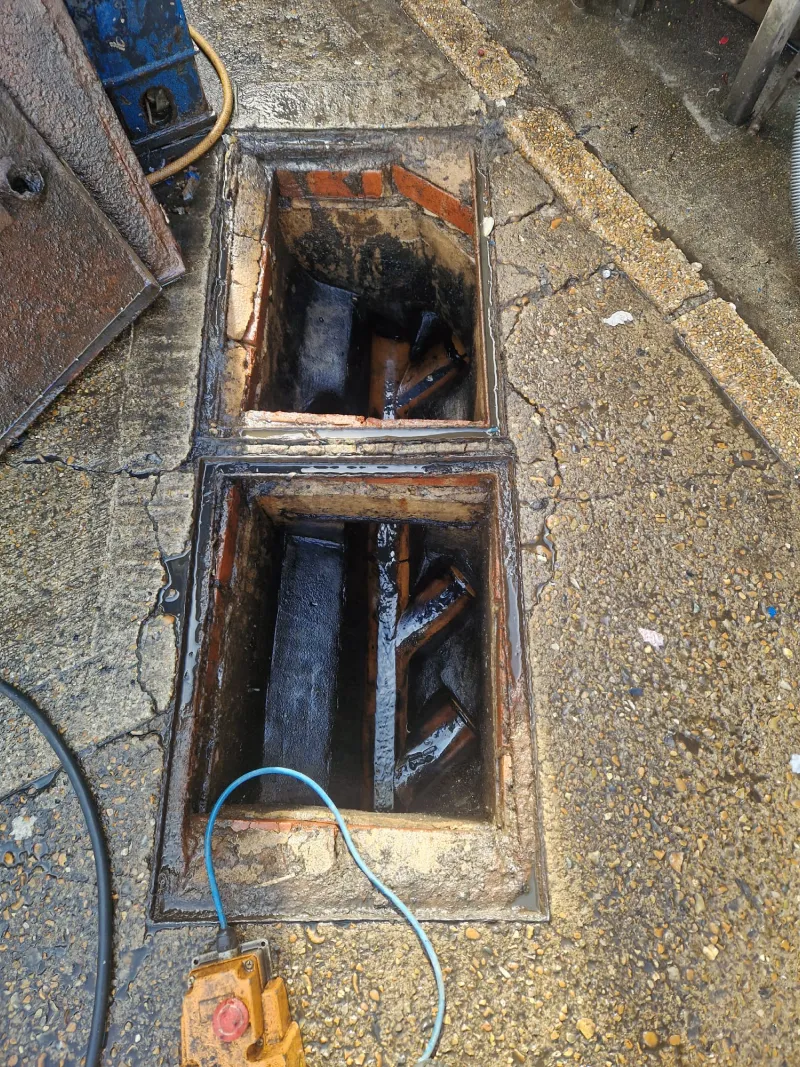 Sewage Spills & Sewer Flooding Across South London & Surrey: 2022-2025 5 Twin brick inspection chambers opened up, showing the drainage channels inside