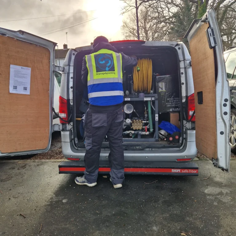 Drainage & Plumbing Ltd emergency drain unblocking van and engineer equipped with high-pressure drain jetter.