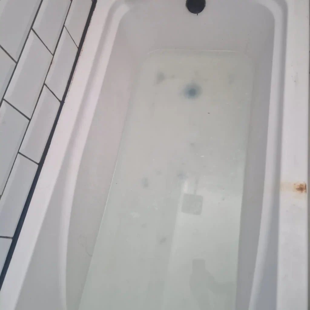blocked sink & bath unblocking services by Drainage & Plumbing Ltd clearing a blocked bath drain