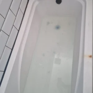 blocked sink & bath unblocking services by Drainage & Plumbing Ltd clearing a blocked bath drain