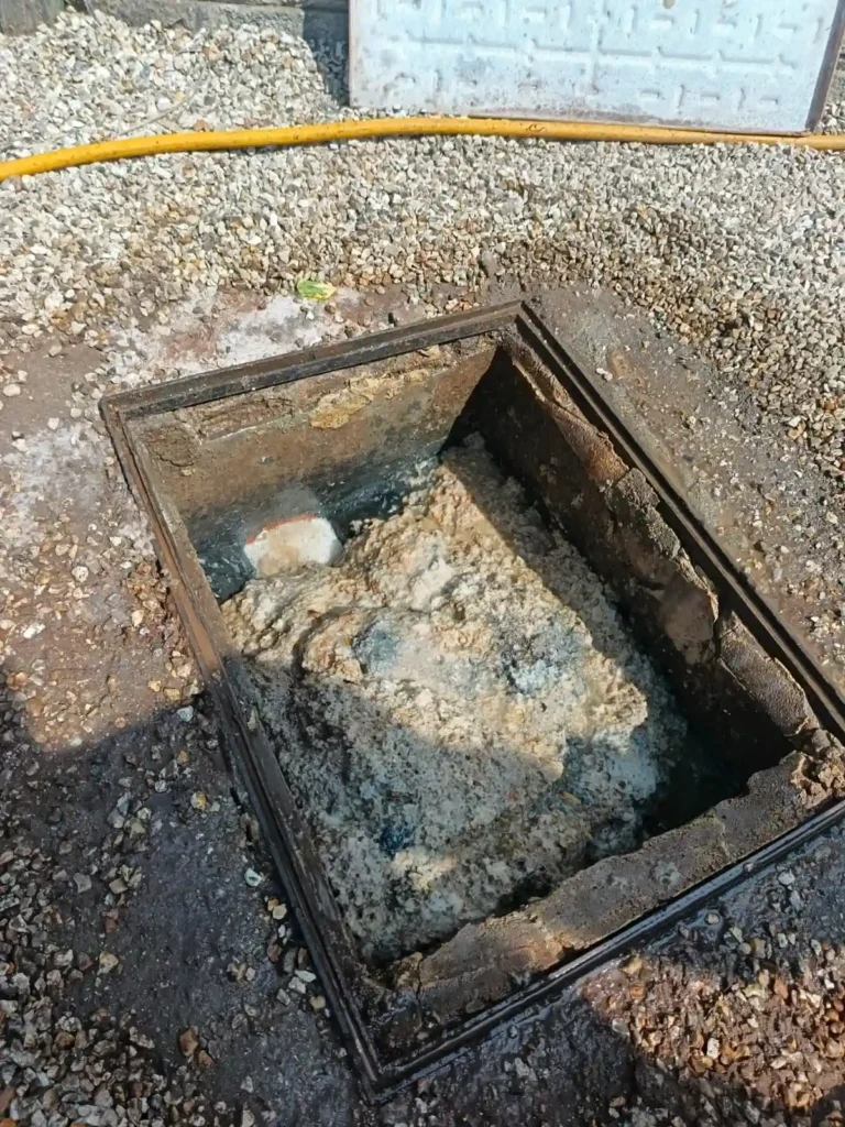 Professional drain unblocking service using high-pressure water jetting equipment