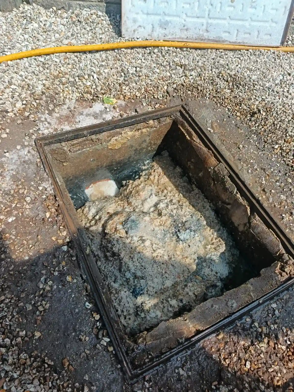 Local Blocked Drain Epsom engineer checking an inspection chamber