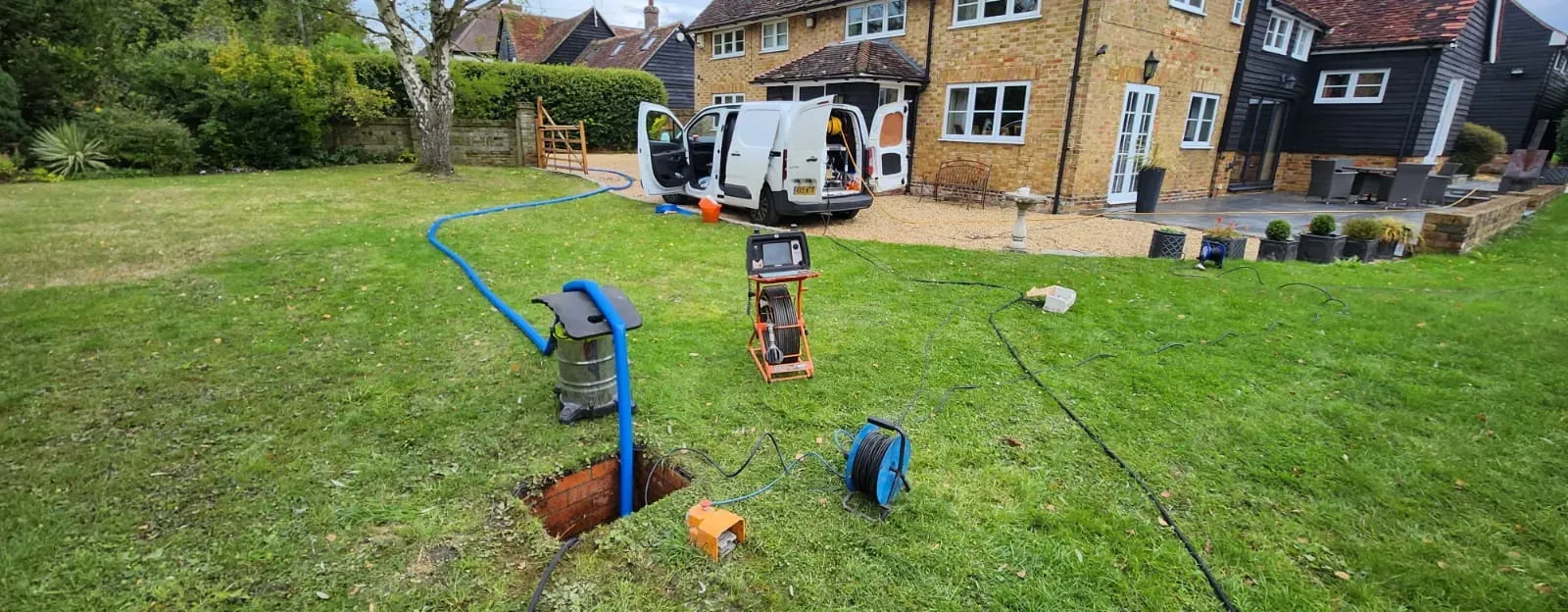 Home 13 High-pressure water jetting equipment in use on a blocked drain callout in South East England