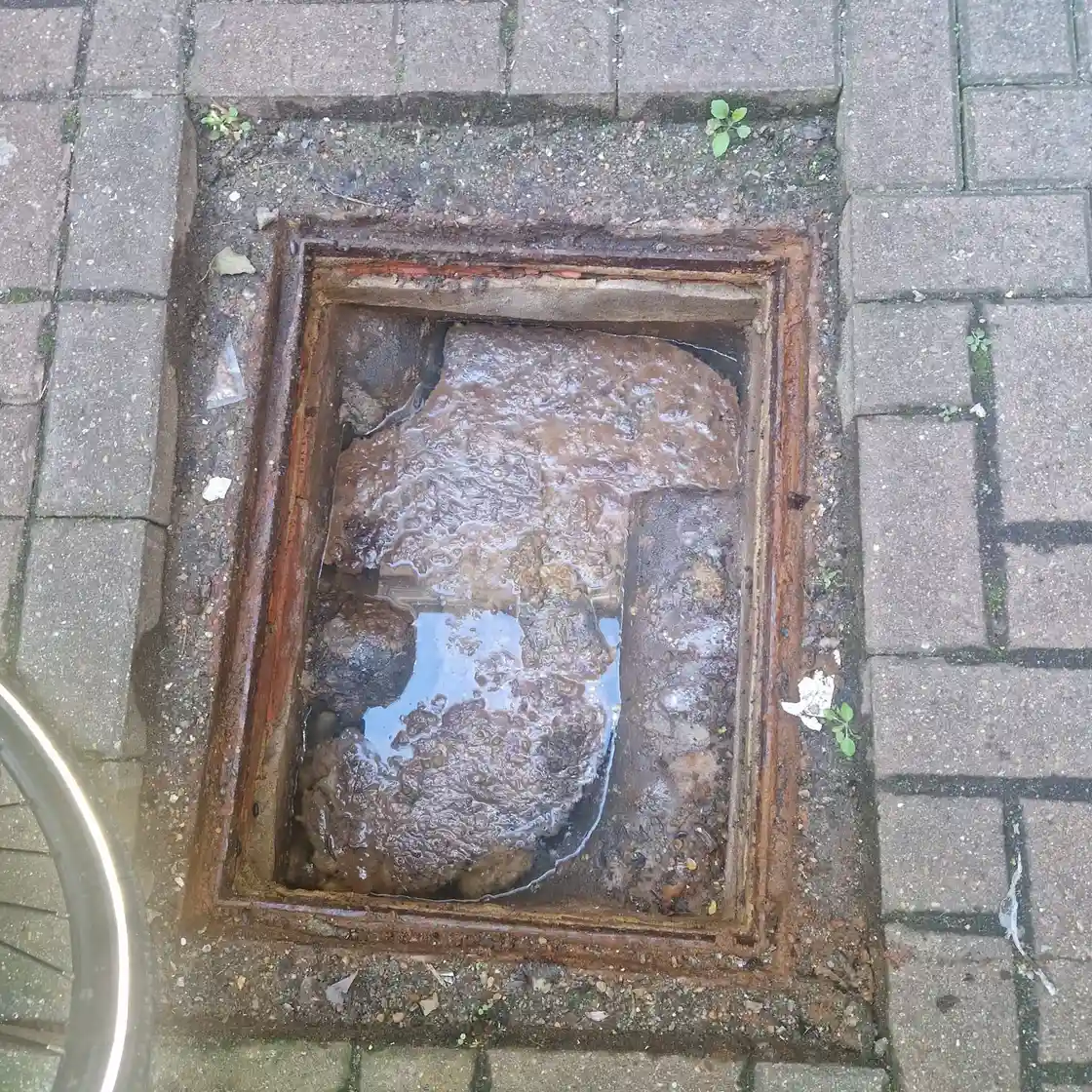 Blocked drain specialist clearing an obstructed outdoor drain