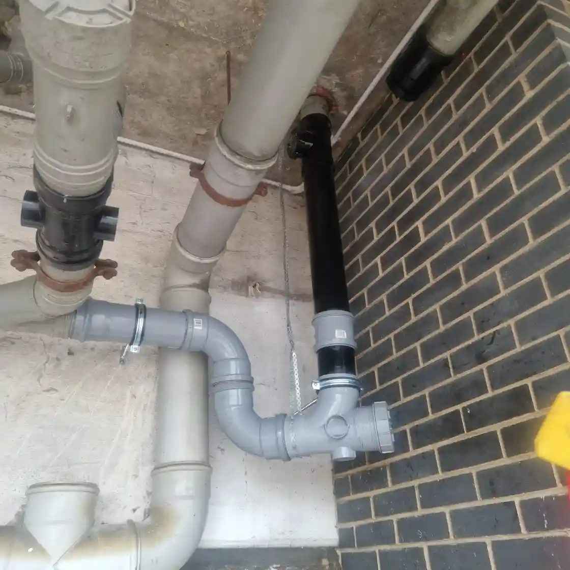 Drainage & Plumbing Ltd performing drain jetting inside an inspection chamber
