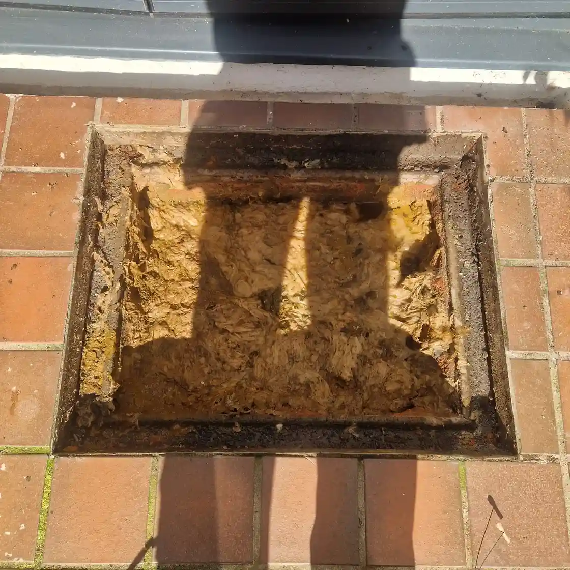 Drainage & Plumbing Ltd clearing blocked inspection chamber using high-pressure jetting