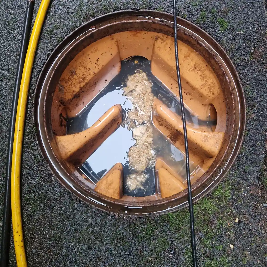 High pressure water jetting clearing a blocked drain in RH7