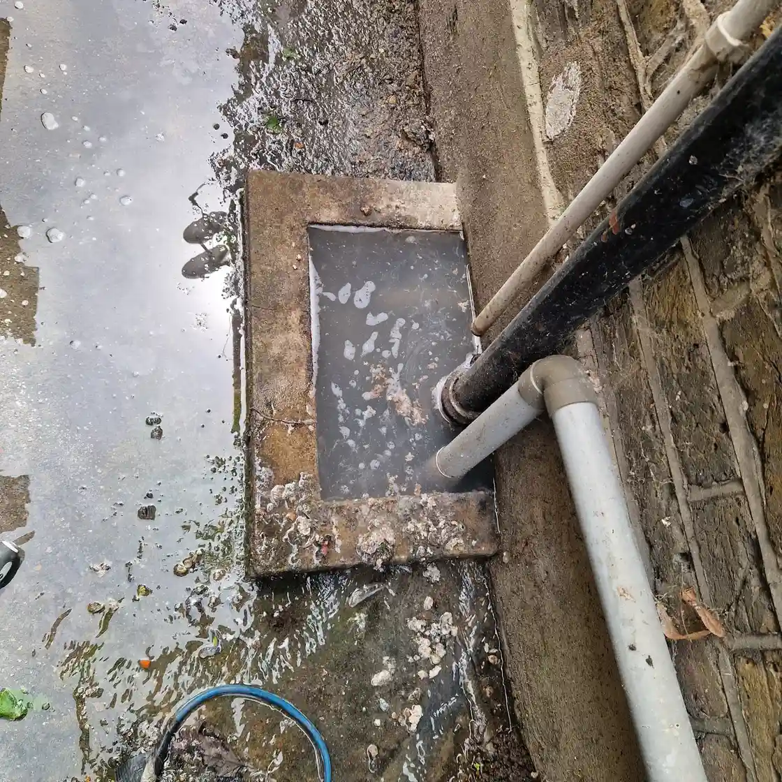 Drainage engineer inspecting a blocked drain in Horley
