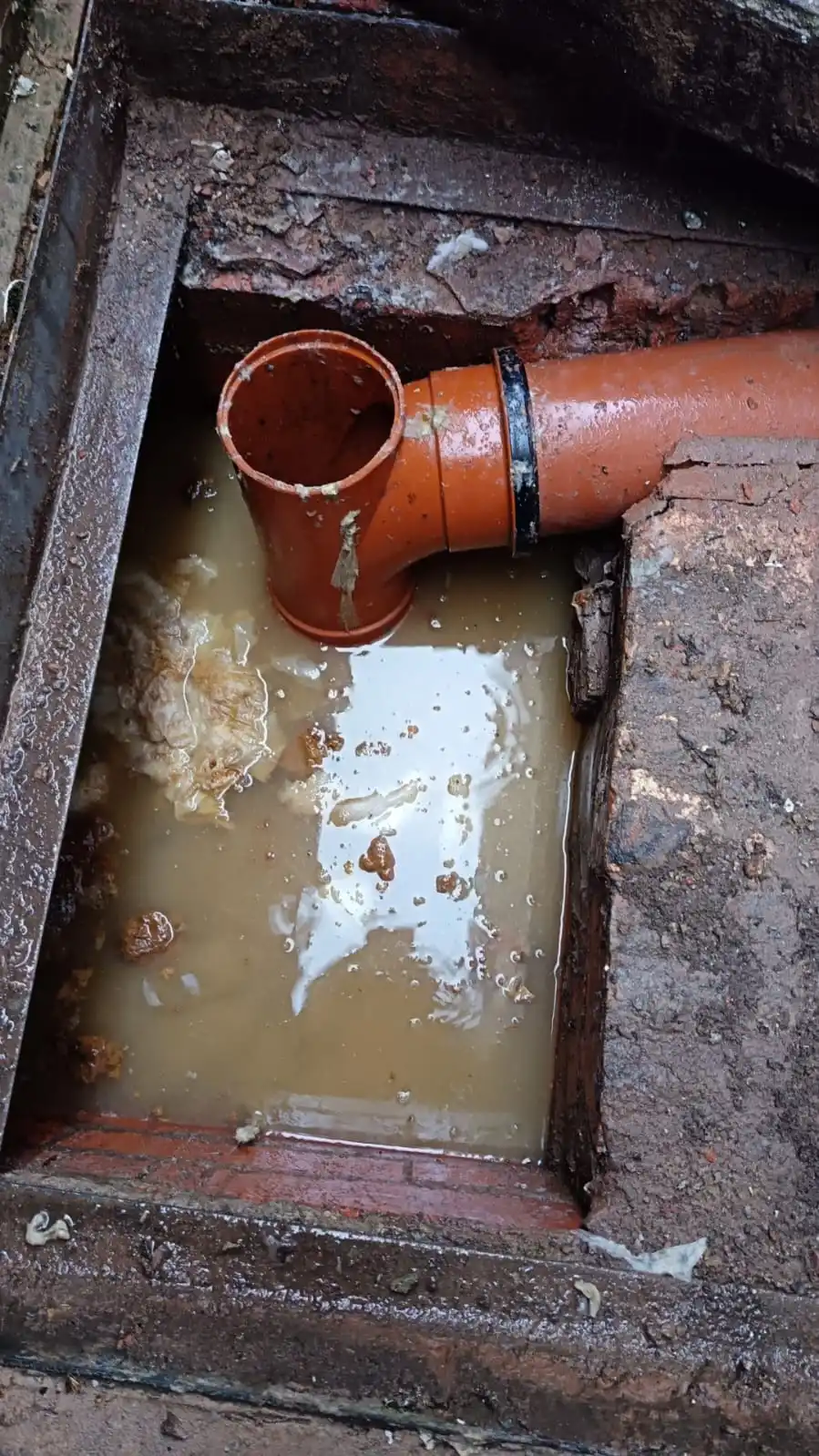 Why Do Drains Smell? Fast Fixes Before It Gets Serious 14 high-pressure water jetting equipment clearing a blocked external manhole chamber to eliminate sewage smell