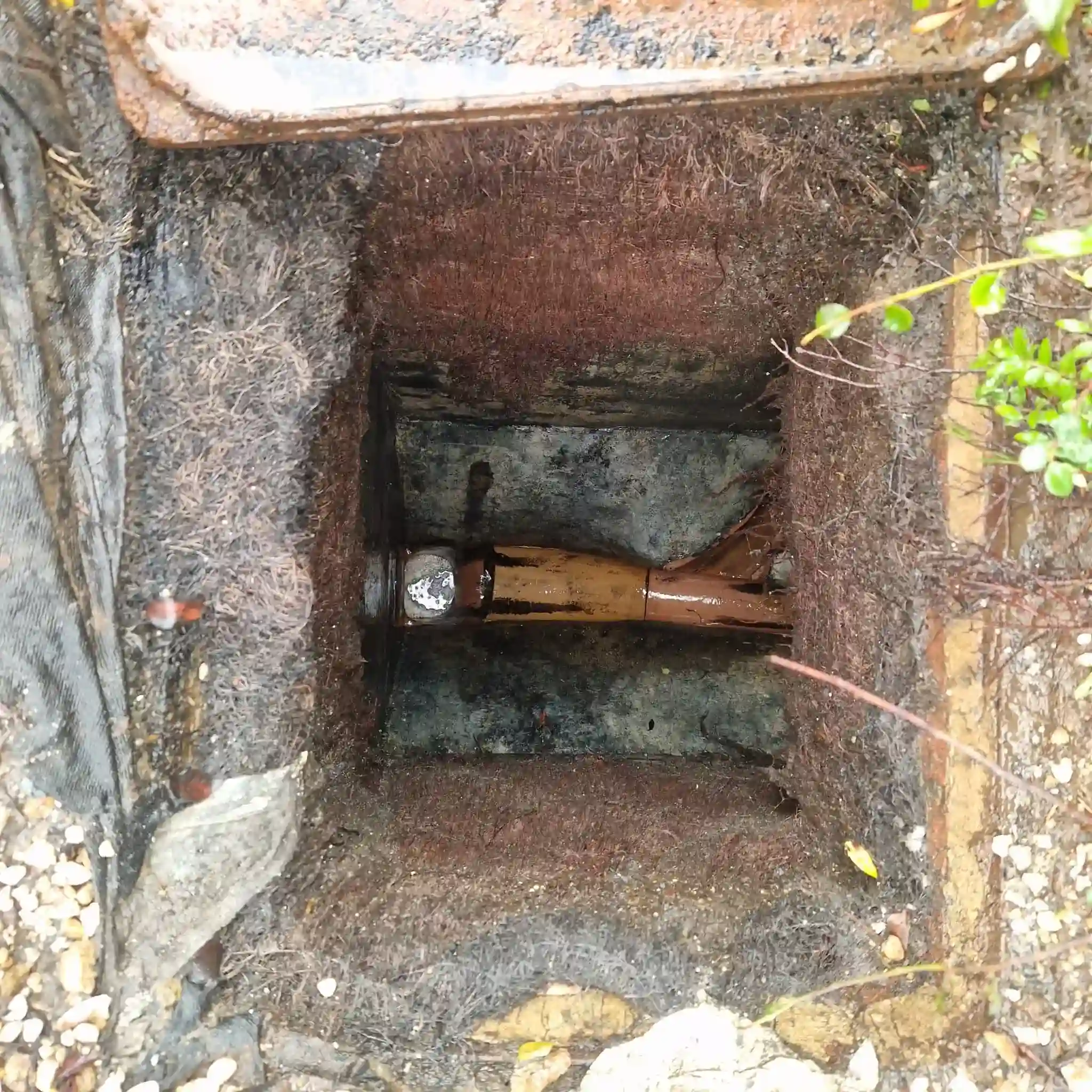 High-pressure drain jetting nozzle clearing grease blockage inside residential pipe in Woldingham