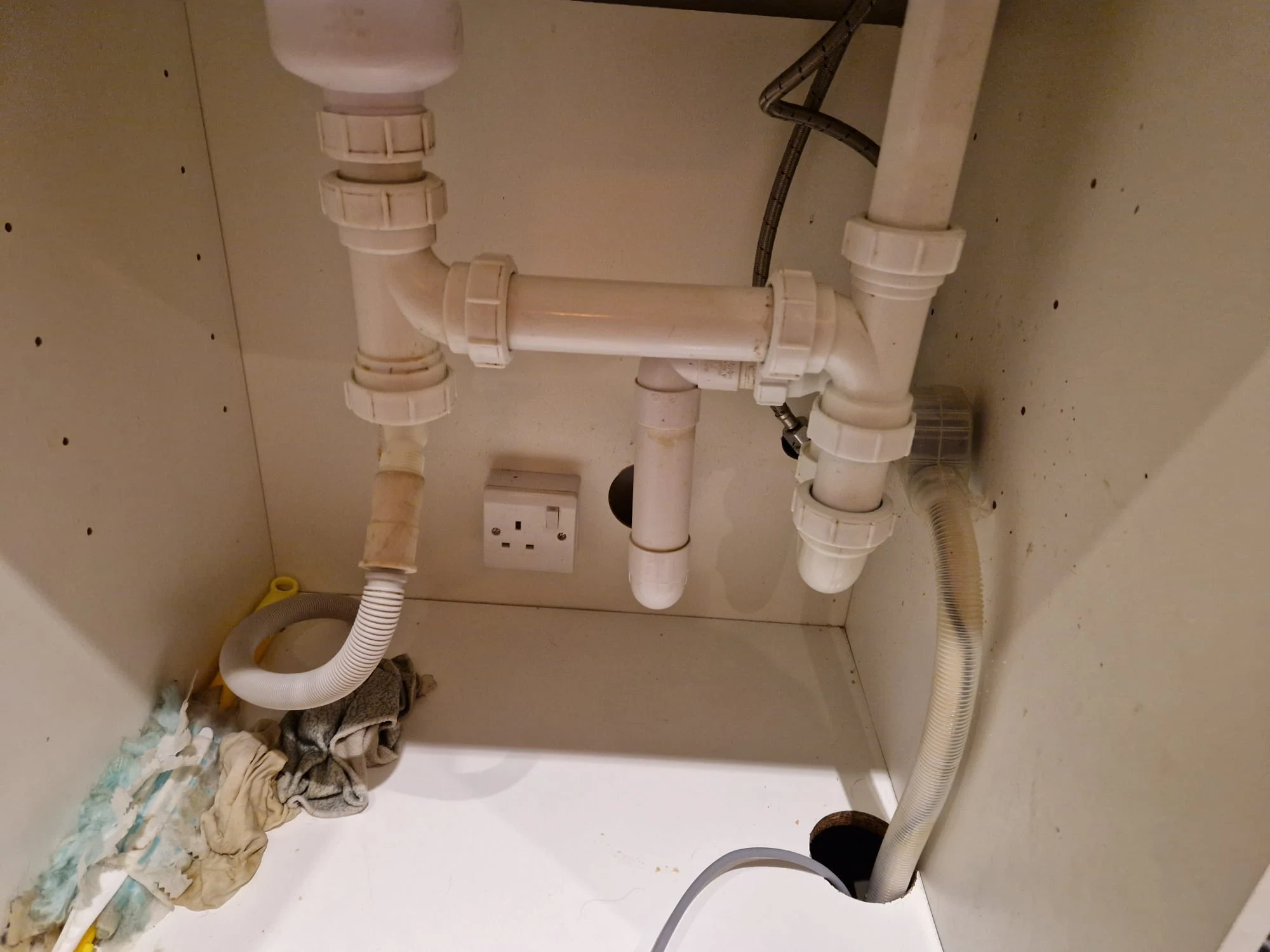 CCTV drain survey camera inserted into manhole cover for blockage diagnosis in South London