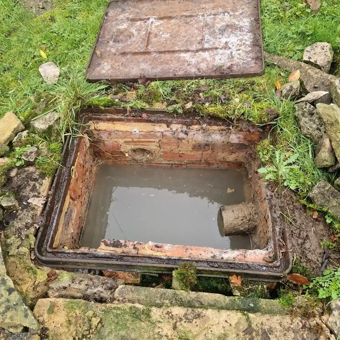 Drainage engineer operating jetting equipment to clear a blocked drain during an emergency call-out