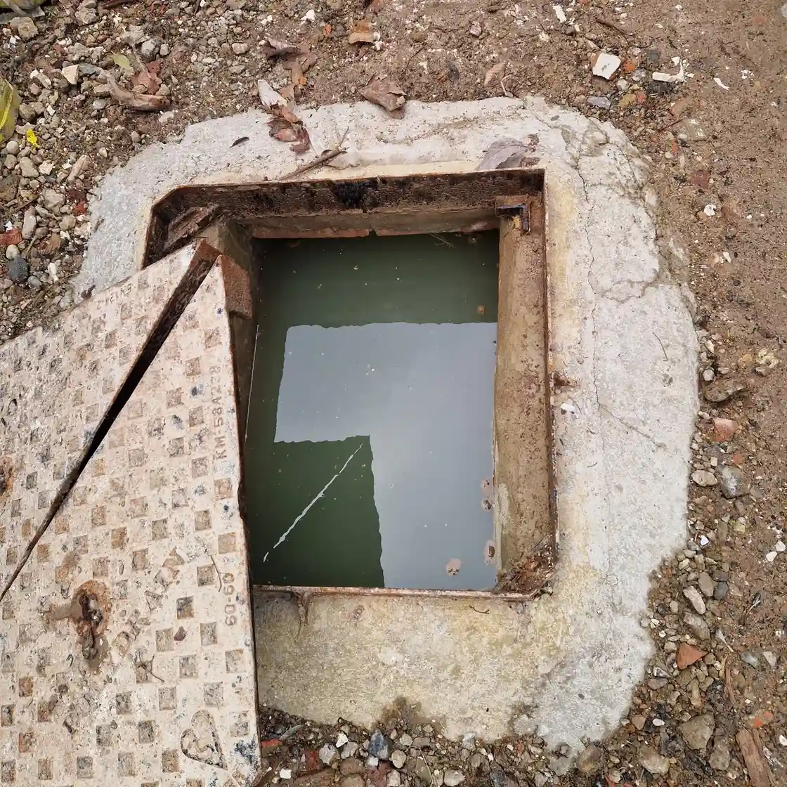 Drainage engineer assessing an emergency blocked drain in Caterham