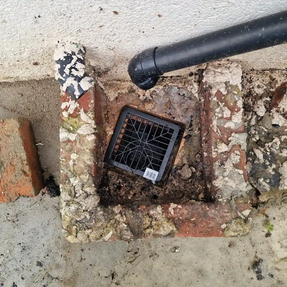 Drainage engineer assessing soil conditions for soakaway installation in Surrey