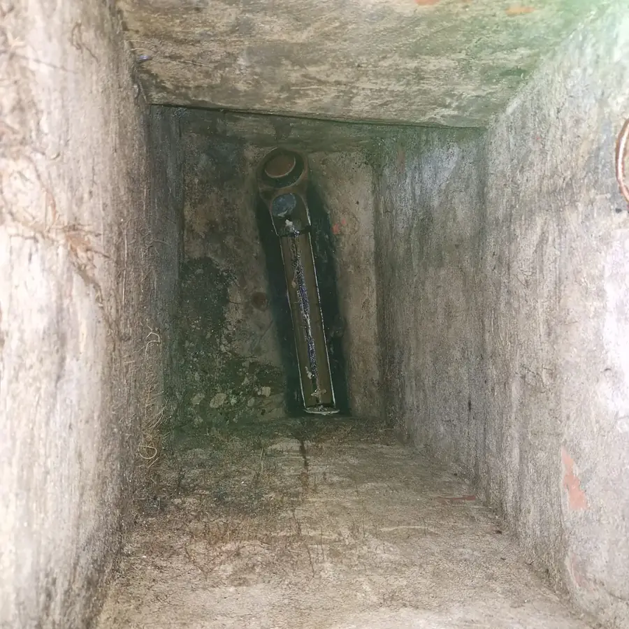 The same chamber after clearing, with the channel back to brick and water running freely