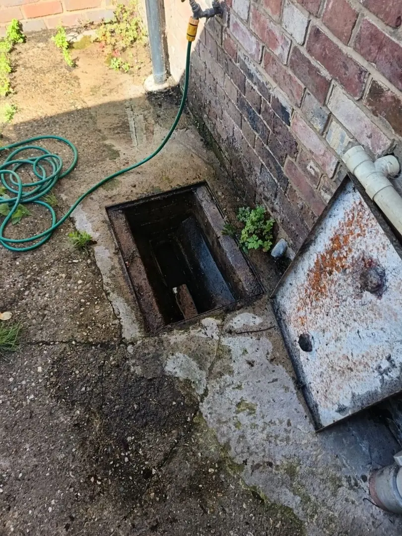 French drain installation tools including perforated pipe and gravel layers